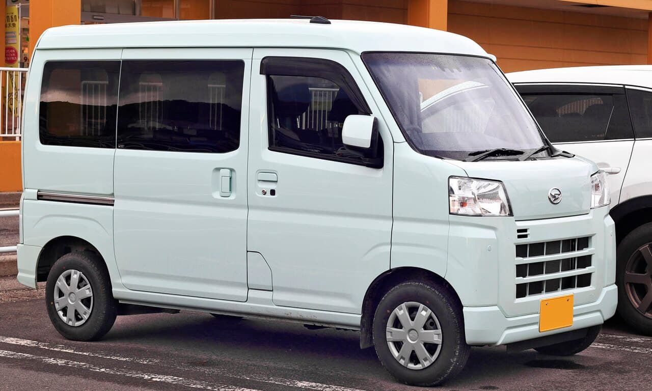 Светло-зелёный Daihatsu Hijet Cargo Cruise одиннадцатого поколения, вид спереди и сбоку